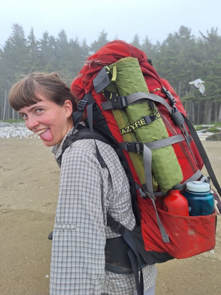 A hiker sticking out her tongue at the camera