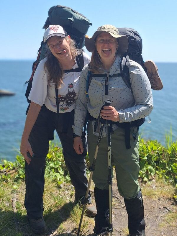 Two hikers making funny faces