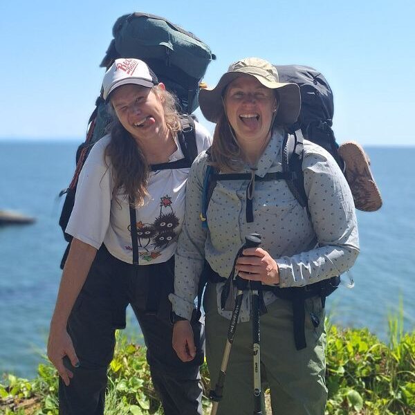 Two hikers making funny faces